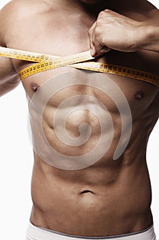 Man measuring his chest. Conceptual image shot