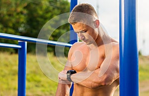 Man measuring time on during street workout