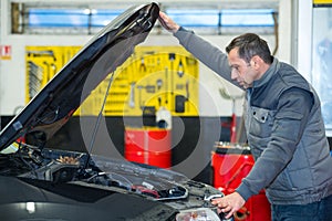 man mechanic repairing car in garage