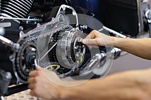 Man mechanic working with screwdriver and repair motorcycle detail