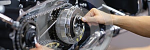 Man mechanic working with screwdriver and repair motorcycle detail