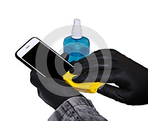 Man in medical gloves disinfects the phone with an antiseptic wet cloth isolated white background. Prevention covod19