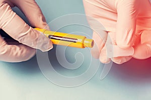 A man in medical gloves holds a syringe for subcutaneous injection of hormonal drugs in the IVF protocol in vitro fertilization Pr