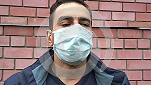 Man in medical mask out of breath, choking, suffocating, ill, heavy cough, breathless, suffer. Portrait