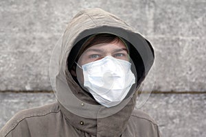 A man in a medical mask, protection against influenza, coronavirus and other viral colds