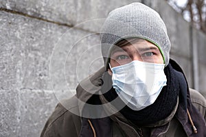 A man in a medical mask, protection against influenza, coronavirus and other viral colds