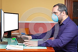 Man with medical mask  working in house. Teleworking concept photo