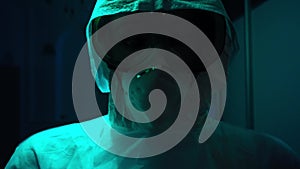 Man in medical protective suit and masks in dark. Stock footage. Mannequin in protective suit against coronavirus or