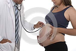 Man in medicine doctor coat using stethoscope listening to fetus heartbeat in pregnant woman big belly