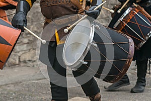 Man in medieval costume plays medieval drum