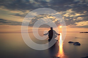 Man meditates on lake water