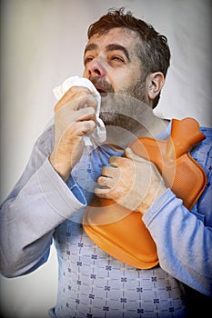 Man Medium-Sized Age In Pajamas Sneezing With A Strong Cold