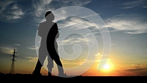 Man meeting woman on the street in sunset and greeting her with a warm handshake.