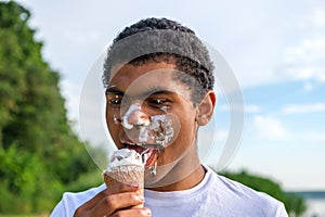 Man with melted ice cream on his face outdoors in summer