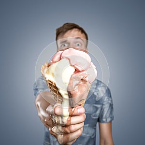 Man with a melting ice cream cone in his hand