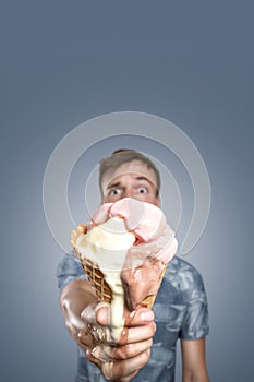 Man with a melting ice cream cone in his hand