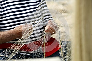 Man Mending Nets