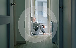 Man with mental disorder sitting on the floor