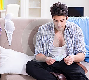 Man with mess at home after house party