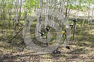 A man with a metal detector on an ancient settlement photographed from a drone