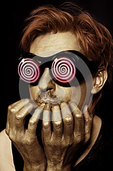 Man with metal makeup in strange glasses