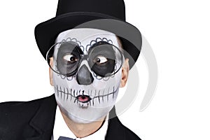 Man with a mexican calaveras makeup crossing his eyes