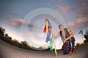 Man middle of a road with ceremonial pole and