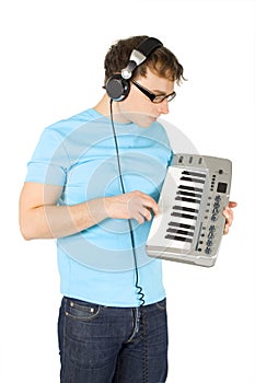 Man with midi keyboard and headphones standing