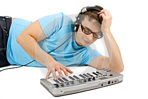 Man with midi keyboard and headphones standing