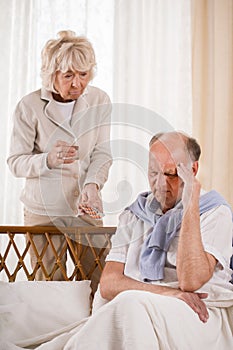 Man with migraine taking painkiller