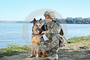 Man in military uniform with German shepherd dog