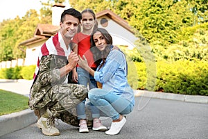 Man in military uniform and his family