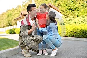 Man in military uniform and his family
