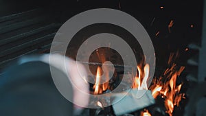 The man mixes coals in a brazier