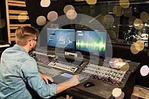 Man at mixing console in music recording studio