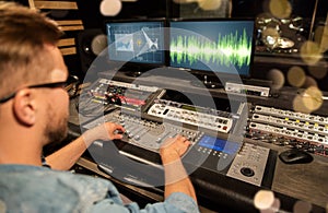 Man at mixing console in music recording studio