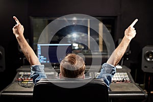 Man at mixing console in music recording studio