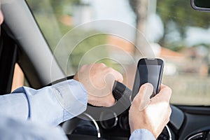 Man with mobile and driving