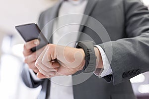 Man with Mobile phone connected to a smart watch