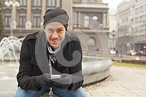 Man With Mobile Phone And Hat In City, Urban Space