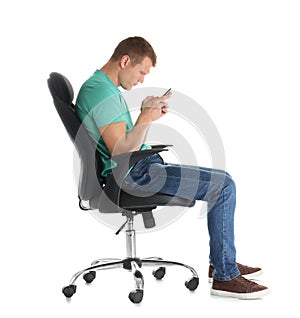 Man with mobile phone sitting in office chair on white background