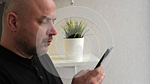 Man with mobile smart phone, side view. Businessman holding smartphone