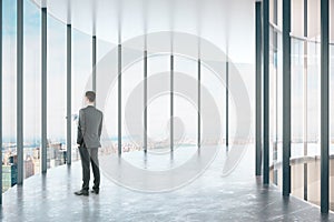 Man in modern glass corridor