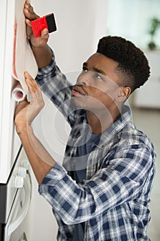 man modernising kitchen cupboards