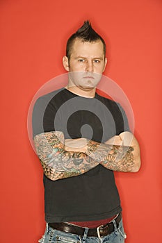 Man with mohawk and tattoos photo