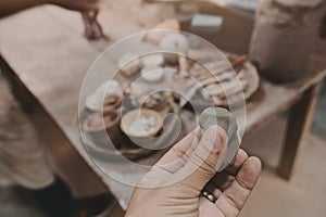 Man molding clay to make ceramics with his hands, Artisan working in his workshop, Selective Focus