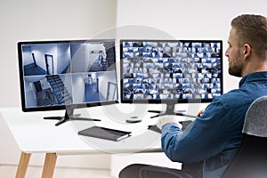 Man Monitoring CCTV Footage