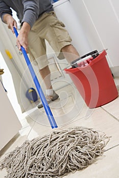 Man Mopping On The Floor