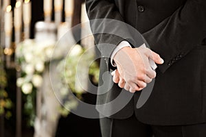 Man or mortician at funeral mourning
