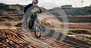 Man, motorcycle and desert for race, adventure or action outdoor with jump stunt at rally. Bike, professional rider and